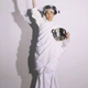 A woman with pots, posting like the Statue of Liberty, by Lu Feifei.